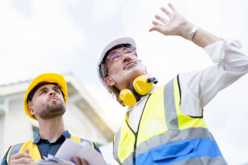 EPC construction crew foreman reviewing plans on job site